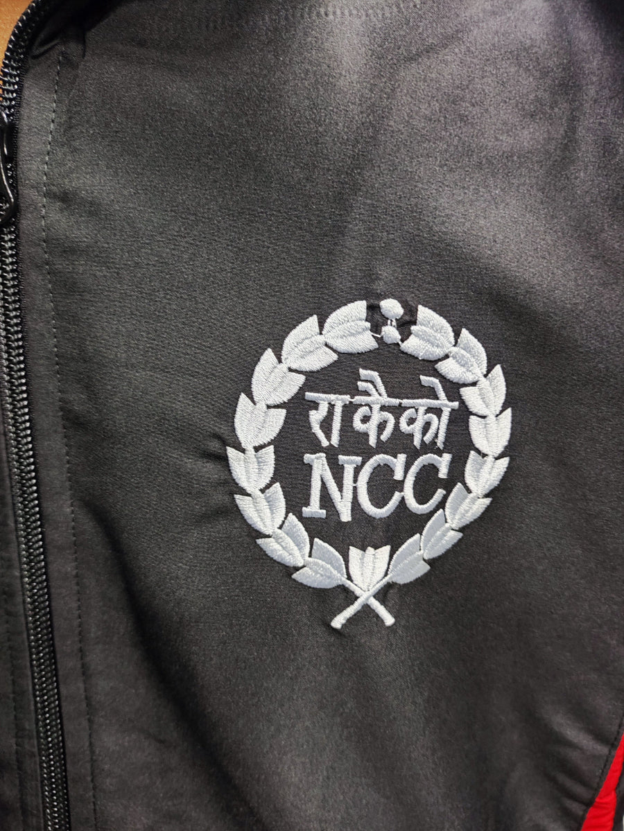 Black jacket with white embroidered logo on a dark background