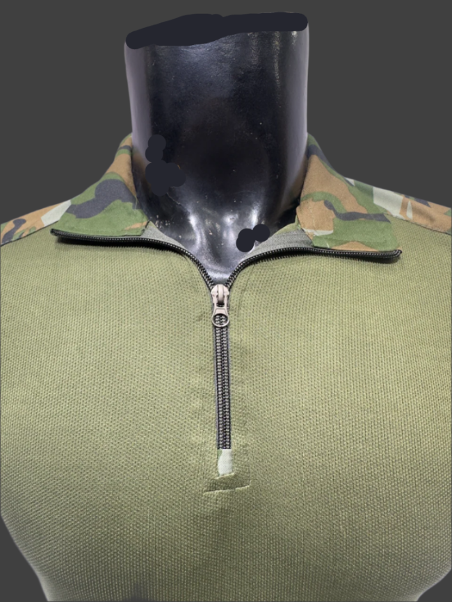 Green military-style jacket with camouflage collar and black zipper on a mannequin.