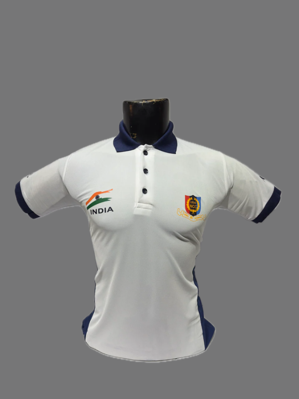 White polo shirt with navy accents on a mannequin against a white background