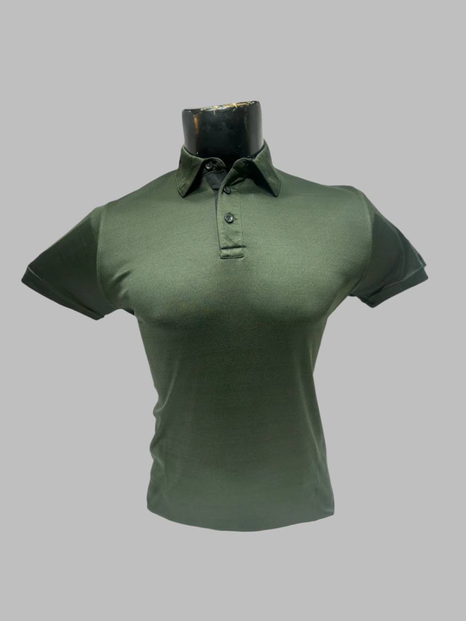 Green polo shirt on a mannequin against a white background
