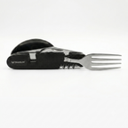 A black and silver multi-tool pocket knife with a built-in stainless steel fork, shown on a clean white background. The brand name 'TRAVELER' is clearly visible on the textured black handle.