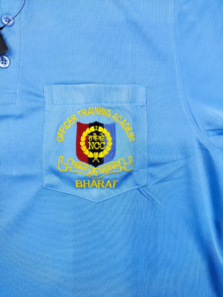 Blue shirt with embroidered badge on chest pocket