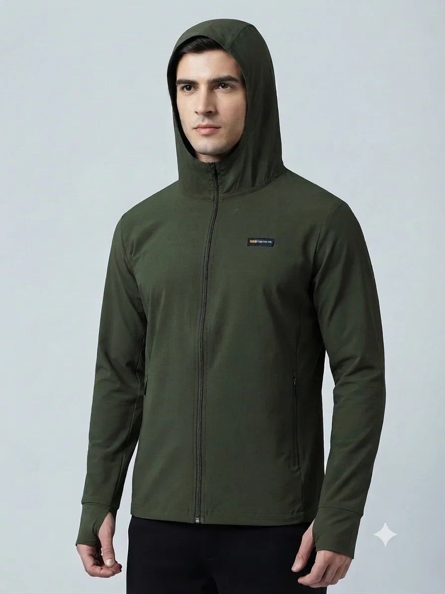 A man wearing a dark olive green hooded zip-up jacket with a small Patagonia logo on the left chest, set against a plain light gray studio background.