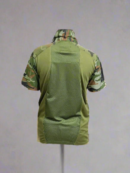 Green tactical shirt with camouflage pattern on a mannequin against a gray background