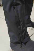 Professional detail shot of tactical tracksuit ankle zipper feature